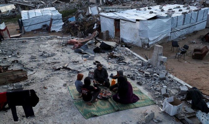 A Palestinian family partakes in an Iftar meal during Ramadan, Jabalia refugee camp, Gaza, Mar. 2, 2025. (Reuters) Accountability is only for Israelis, not Palestinians