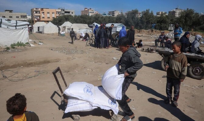 Palestinians boys load UNRWA food aid onto a cart, Nuseirat refugee camp, Gaza, Mar. 3, 2025. (AFP) Building a world where justice trumps power