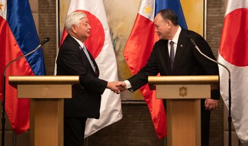 Philippines’ Secretary of National Defence Gilberto Teodoro, right, shakes hands with Japan’s Defense Minister Gen Nakatani.