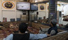 In this photo taken on August 9, 2022, Afghan men watch television in a restaurant in Kabul. (AFP)