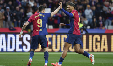 Barcelona routs 10-man Real Sociedad 4-0 to go top in Spain