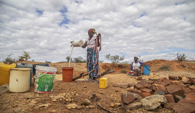 Villagers fetch water from a makeshift borehole in Mudzi, Zimbabwe, July 2, 2024. (AP)