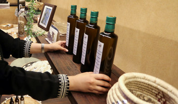 A Saudi trader, displays moringa oil products in her shop in the old town, in AlUla, Saudi Arabia October 31, 2021. (REUTERS)